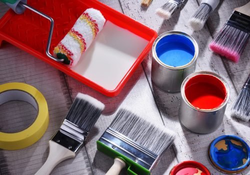 Paint can and paintbrushes of different size  for home decorating purposes.